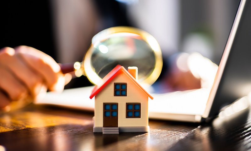Landlord calculating rental income from properties in a well-organized office setting.
